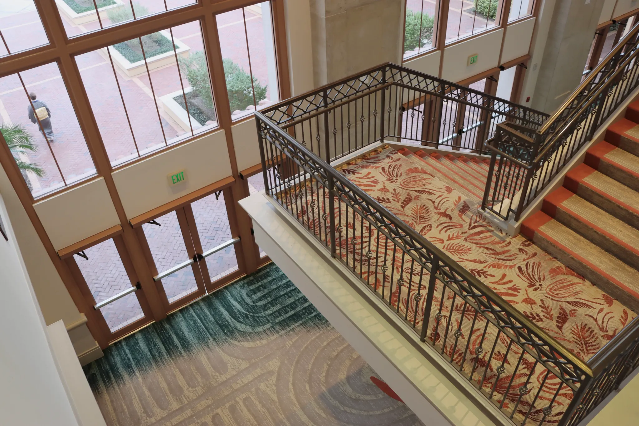 Staircase with patterned carpet in a spacious lobby