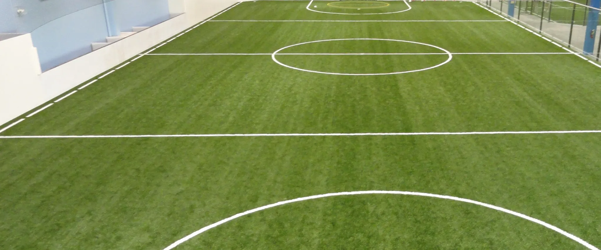 Indoor artificial turf soccer field with white markings