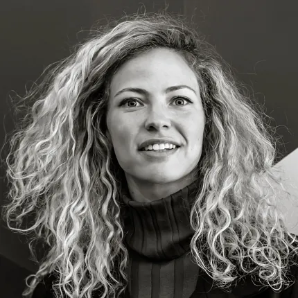Black and white portrait with geometric background Black and white image of a person with curly hair against a geometric background