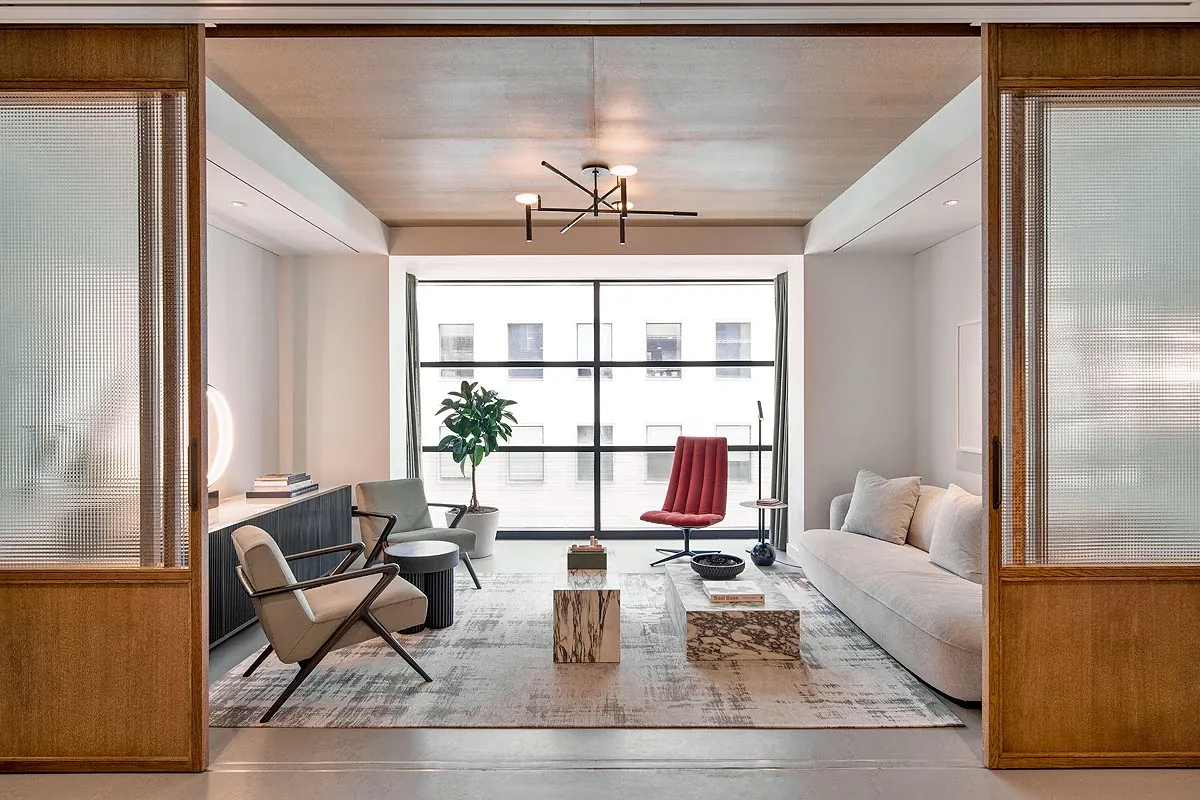 Modern living room with stylish furniture and large windows