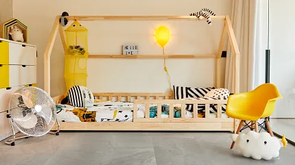 Gray Stone Look Luxury Vinyl Tile Flooring in Children's Room - Durable and Stylish. Modern children's room with gray stone look luxury vinyl tile flooring, featuring a wooden bed, yellow chair, and playful decor.
