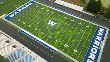 Warren Warriors Football Field with Artificial Turf Aerial view of a football field with artificial turf featuring the "Warren Warriors" logo and markings