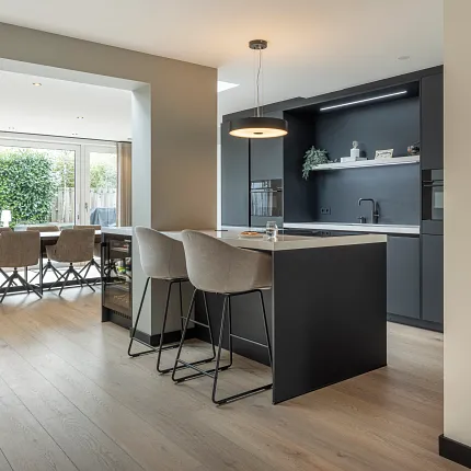 Modern kitchen and dining area with light wood flooring