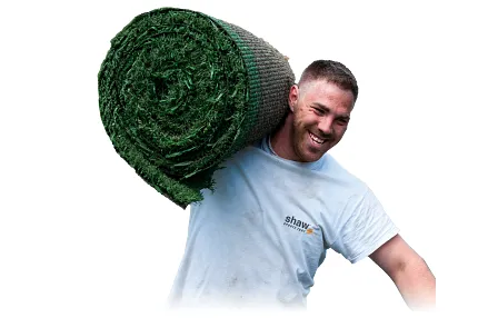 Man with artificial grass roll on shoulder Man carrying a roll of artificial turf on shoulder