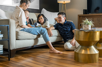 A family in a living room with luxury vinyl flooring visible