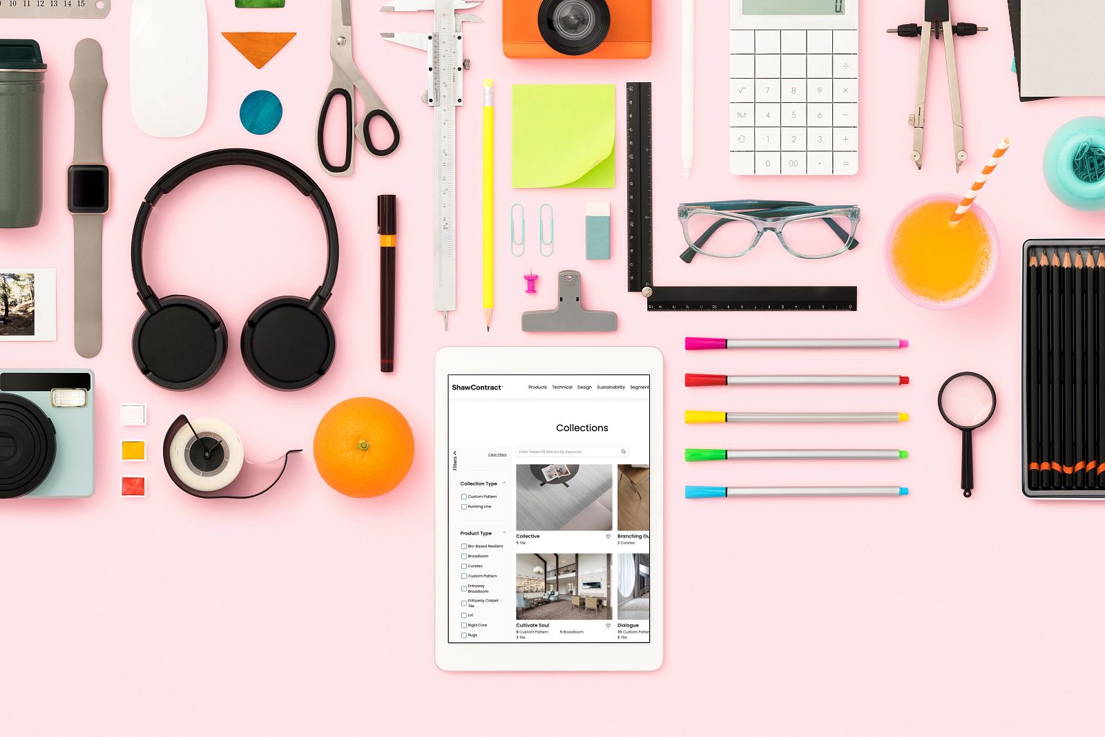 Creative workspace with tablet showing flooring options Overhead view of a creative workspace with various office supplies and a tablet displaying flooring collections