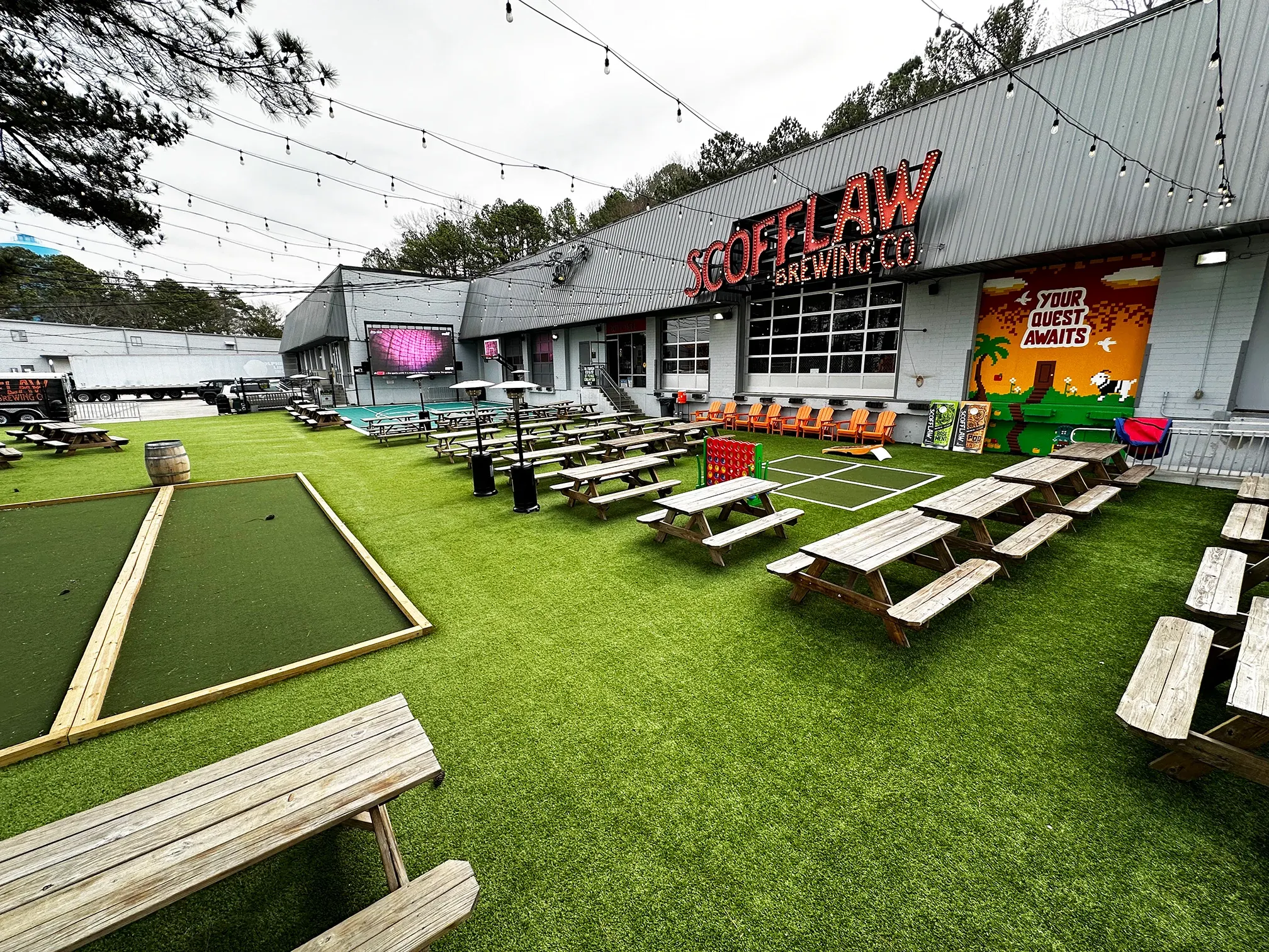 Outdoor seating area with artificial grass at Scofflaw Brewing Co