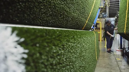 Durable artificial turf for versatile applications Artificial grass rolls in a factory setting