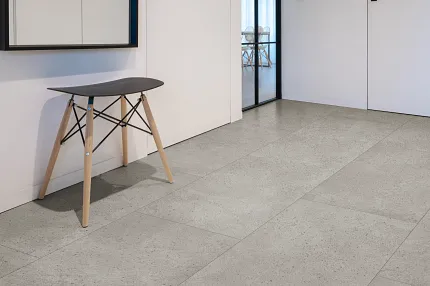 Light Gray Stone Look Luxury Vinyl Tile Flooring in Modern Room Modern room with light gray stone look luxury vinyl tile flooring and minimalist furniture