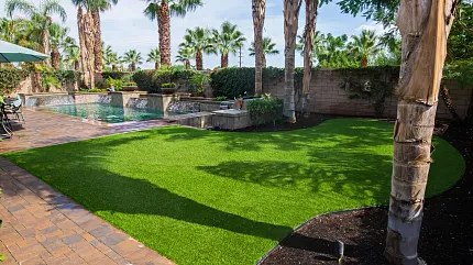 Vibrant synthetic lawn for outdoor spaces Lush artificial grass in a tropical backyard setting