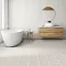 <h2 class="text-bodycopy-l"><span style="color:#ffffff;"><strong>Need Design Help?</strong></span></h2>
Modern bathroom with white freestanding bathtub, wooden vanity, and light beige tile flooring
