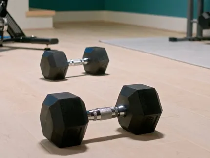Light Wood Look LVP Flooring in Home Gym - Durable and Scratch Resistant Home gym with dumbbells on light wood look luxury vinyl plank flooring