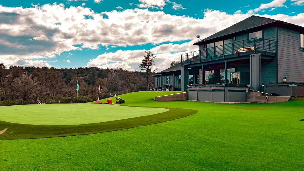 Modern house with lush green artificial turf lawn