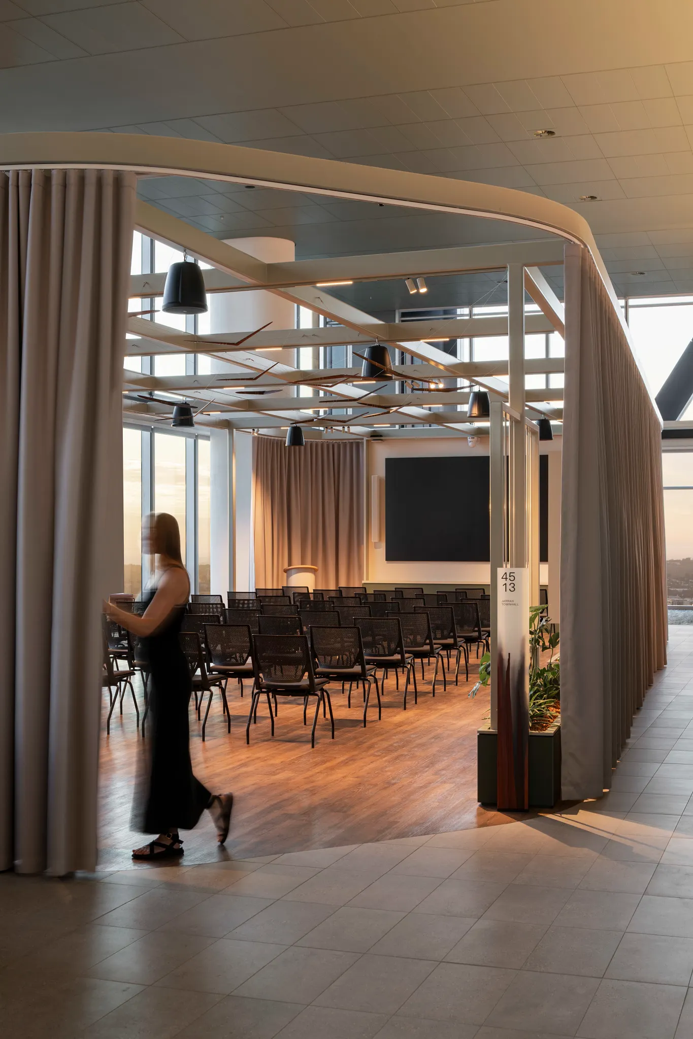 Modern conference room with wood-look flooring and seating arrangement