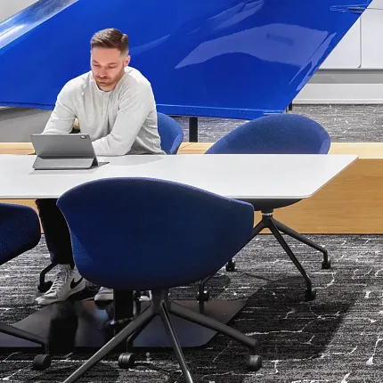 Contemporary office design with stylish carpet flooring Modern office space with blue chairs and textured carpet flooring