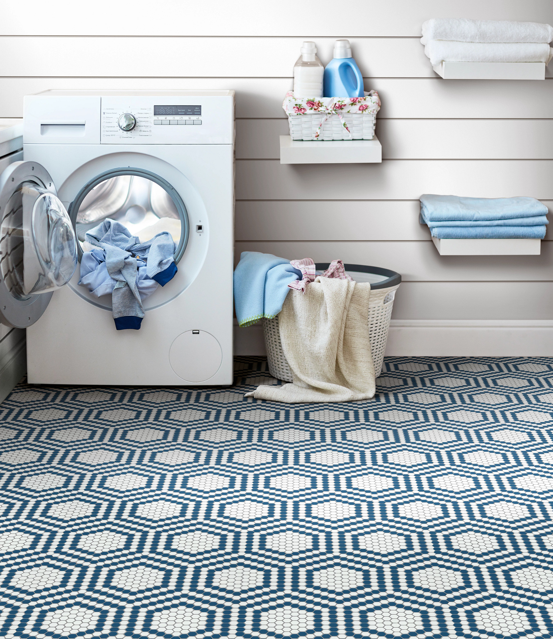 Farmhouse style laundry room with shiplap walls and blue and white vintage mosaic flooring