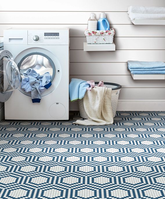 Farmhouse style laundry room with shiplap walls and blue and white vintage mosaic flooring