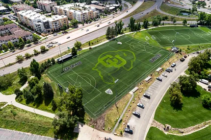 Colorado Buffaloes sports field with artificial turf - aerial view Aerial view of a sports field with artificial turf featuring the Colorado Buffaloes logo