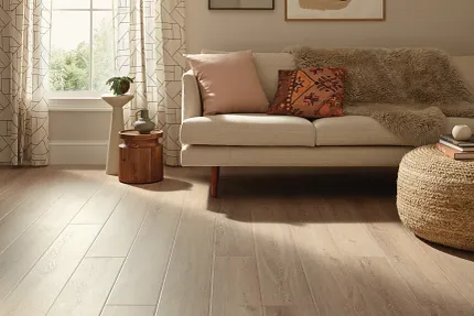Coretec Residential WPC Luxury Vinyl Plank Flooring in Living Room Scene Cozy living room with beige sofa and Coretec Residential WPC luxury vinyl plank flooring in a wood look, 59.84x7.05 inch dimensions