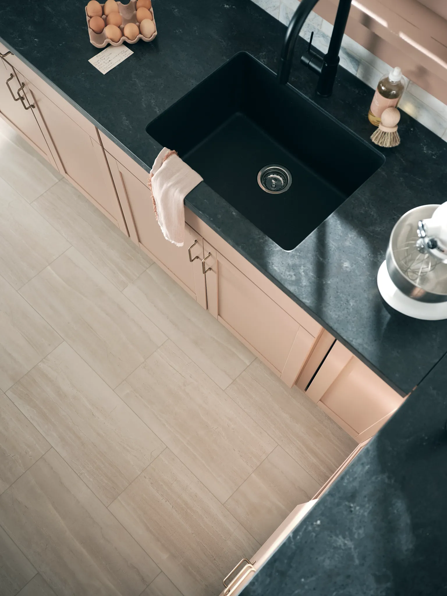 Modern kitchen with beige luxury vinyl tile flooring and black sink