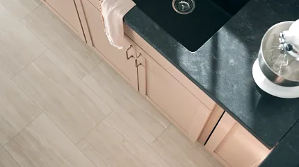 Beige Luxury Vinyl Tile Flooring in Modern Kitchen - 24x12 inch Modern kitchen with beige luxury vinyl tile flooring and black sink