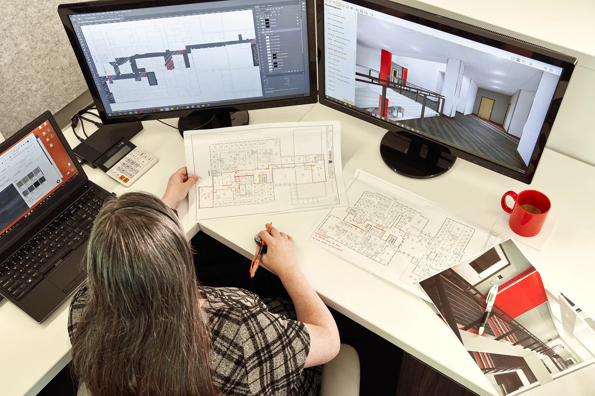 Designer working on architectural plans with flooring design on computer screens