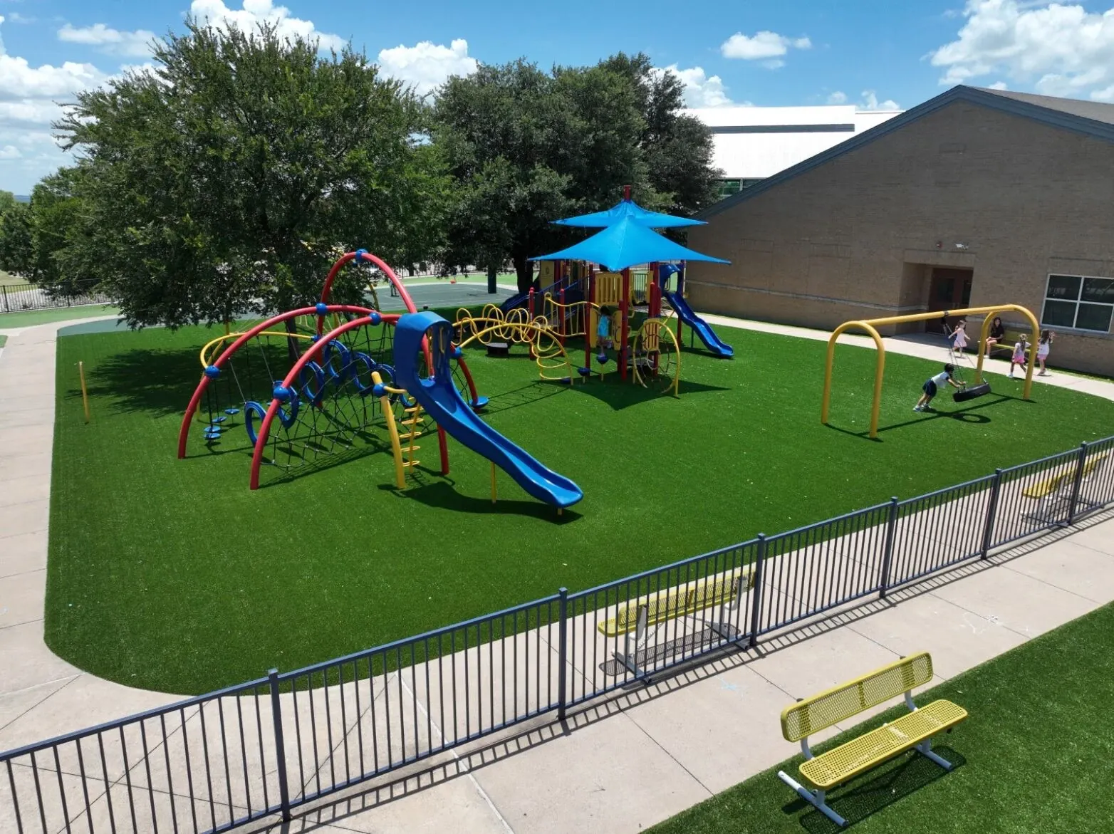 Playground with artificial grass and colorful equipment