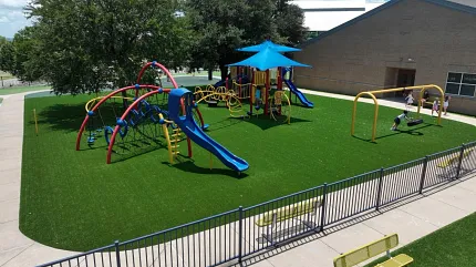 Durable artificial grass for playgrounds Playground with artificial grass and colorful equipment