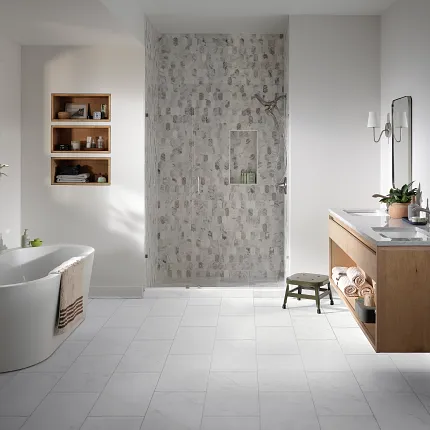 Coretec Residential WPC Luxury Vinyl Tile Flooring in Modern Bathroom - 24.02x12.01 inch Modern bathroom with Coretec Residential WPC luxury vinyl tile flooring in a light stone look, featuring a freestanding bathtub, wooden vanity, and glass shower, 24.02x12.01 inch dimensions