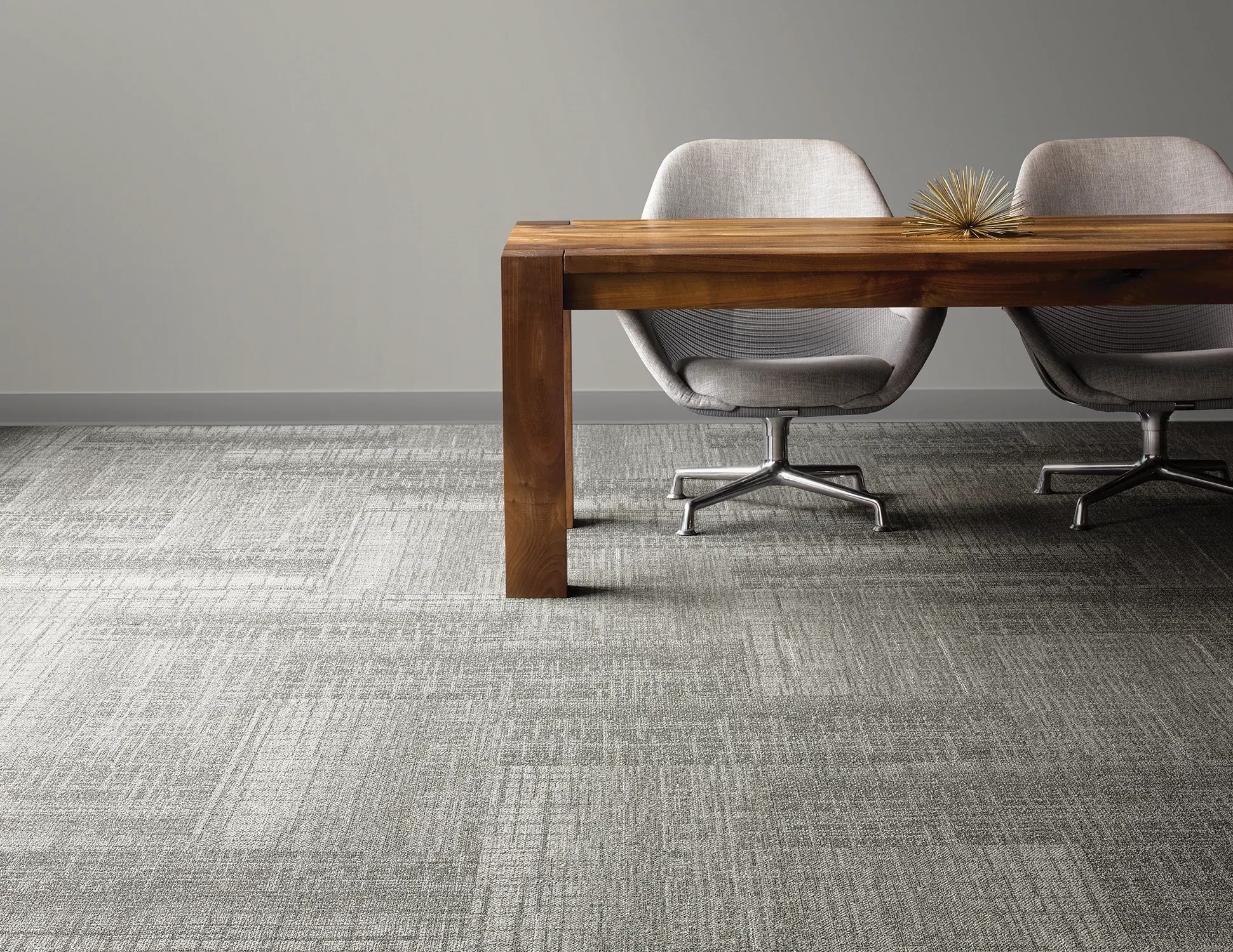 Modern office with gray carpet tiles and wooden desk