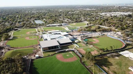 Sports complex with artificial turf baseball fields aerial view Aerial view of sports complex with multiple baseball fields covered in artificial turf
