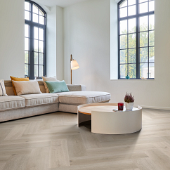 A room with herringbone luxury vinyl flooring.