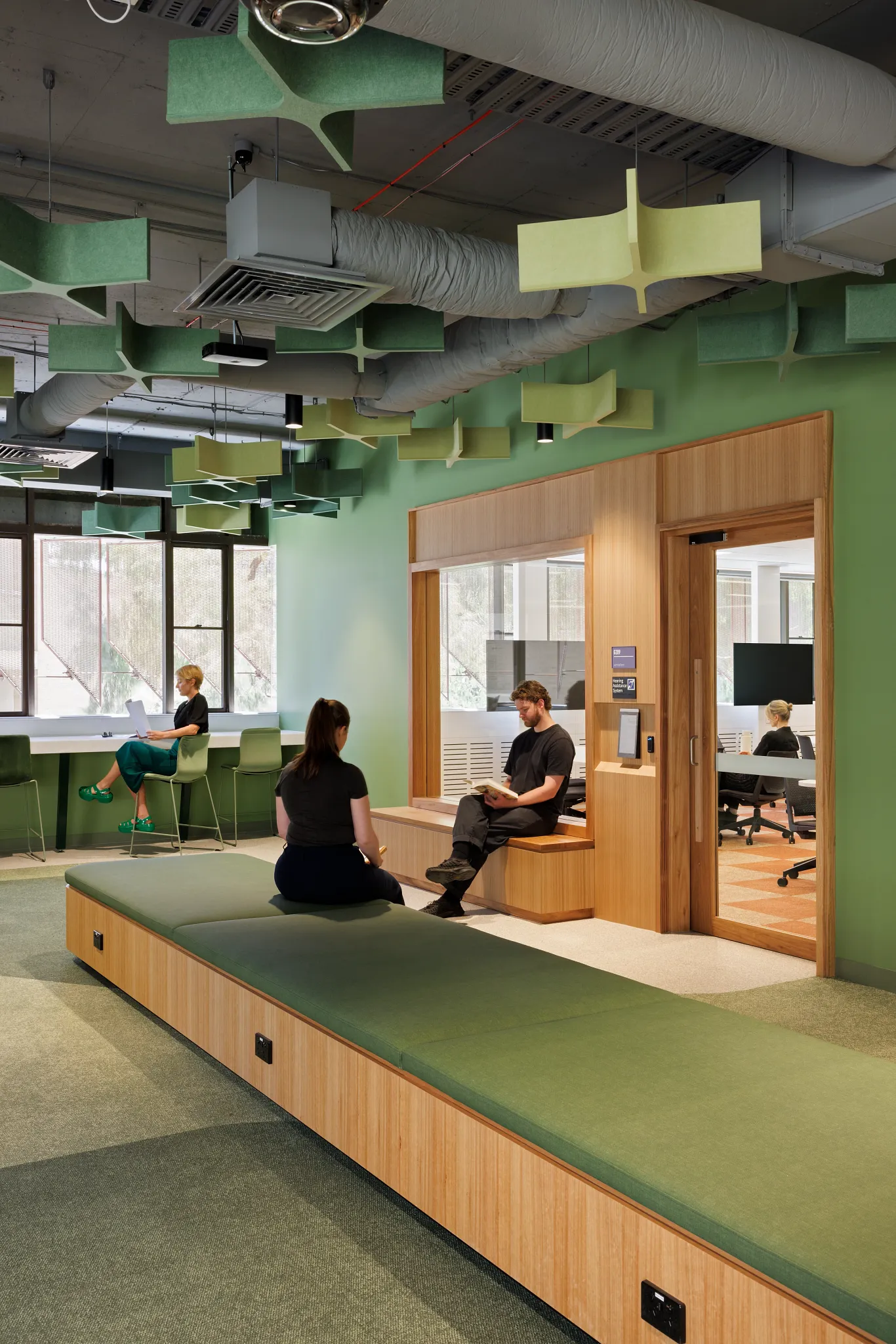 Modern higher education lounge with green carpet flooring