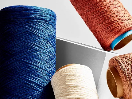 Vibrant yarn selection for textile projects Spools of yarn in blue, white, and terracotta colors