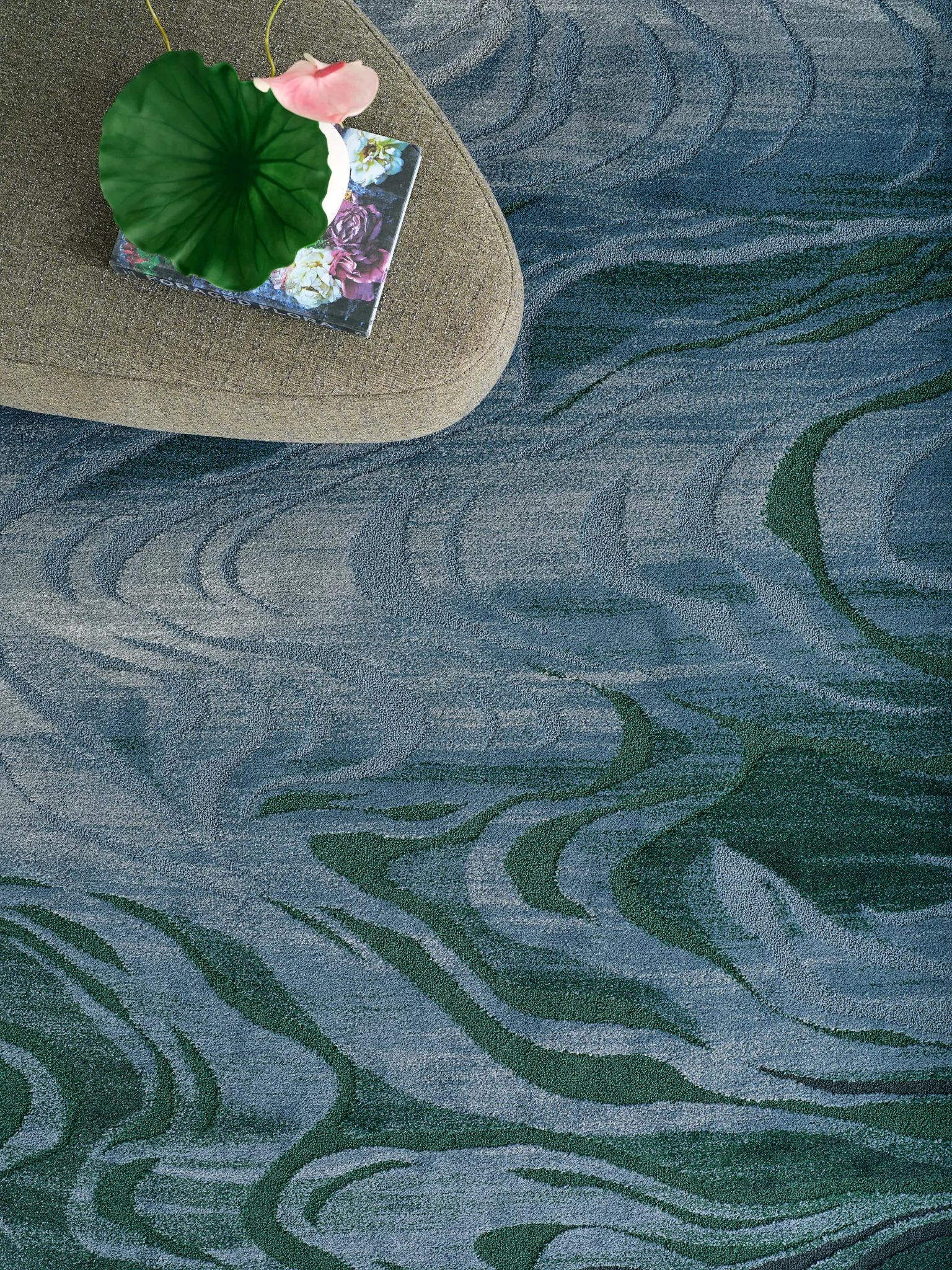 Blue and green patterned carpet with floral decor
