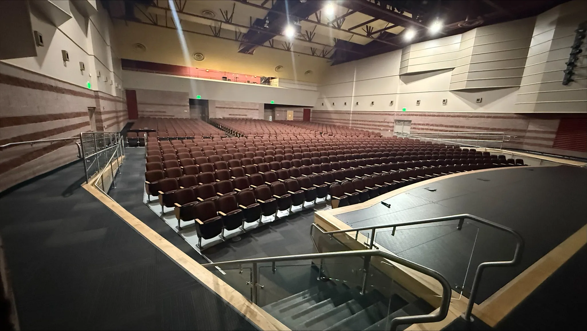 Auditorium with tiered seating and stage in an education facility