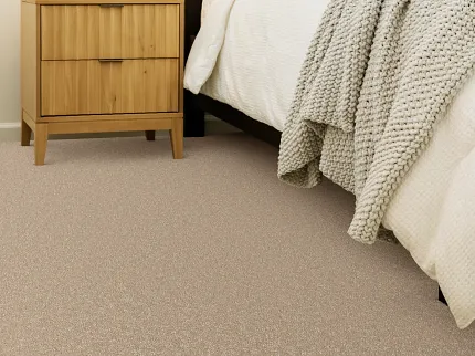 Comfortable and Durable Beige Carpet Flooring for a Cozy Bedroom Cozy bedroom with beige carpet flooring, wooden nightstand, and dark headboard