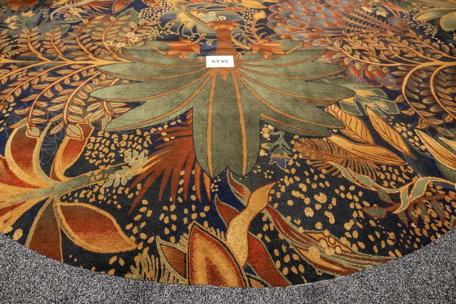 Vibrant floral patterned carpet with green, orange, and blue hues