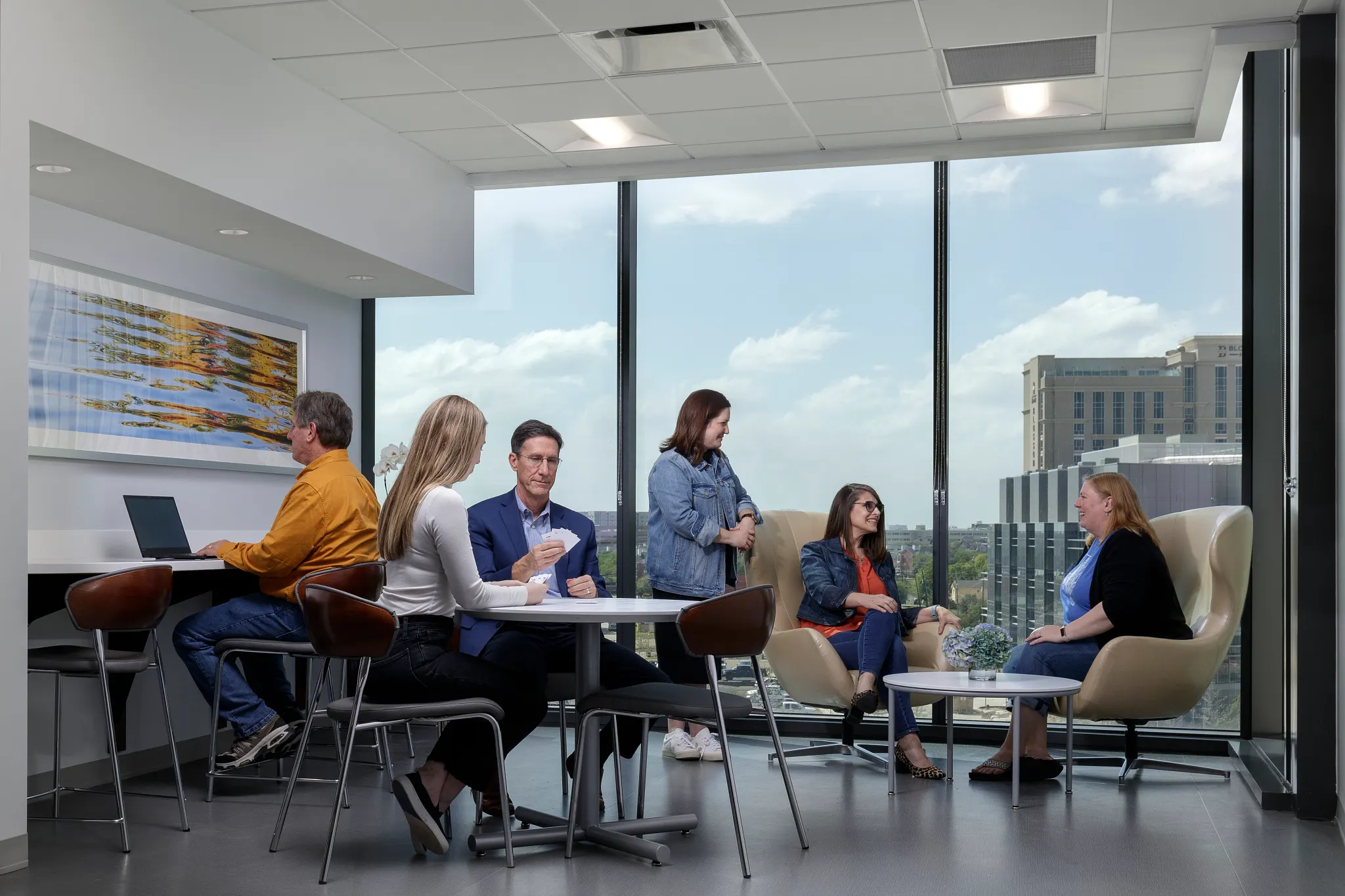 Modern workplace meeting area with large windows and sleek flooring