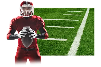 Football player in red uniform holding ball in front of green turf field with white yard lines. Football player in red uniform holding ball in front of green turf field with white yard lines.