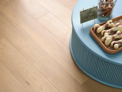 Light Wood Look Luxury Vinyl Plank Flooring - Coretec Residential SPC, 49x7.13 inch Light wood look luxury vinyl plank flooring in a residential setting with a blue table and dog treats, 49x7.13 inch dimensions, Coretec Residential SPC construction