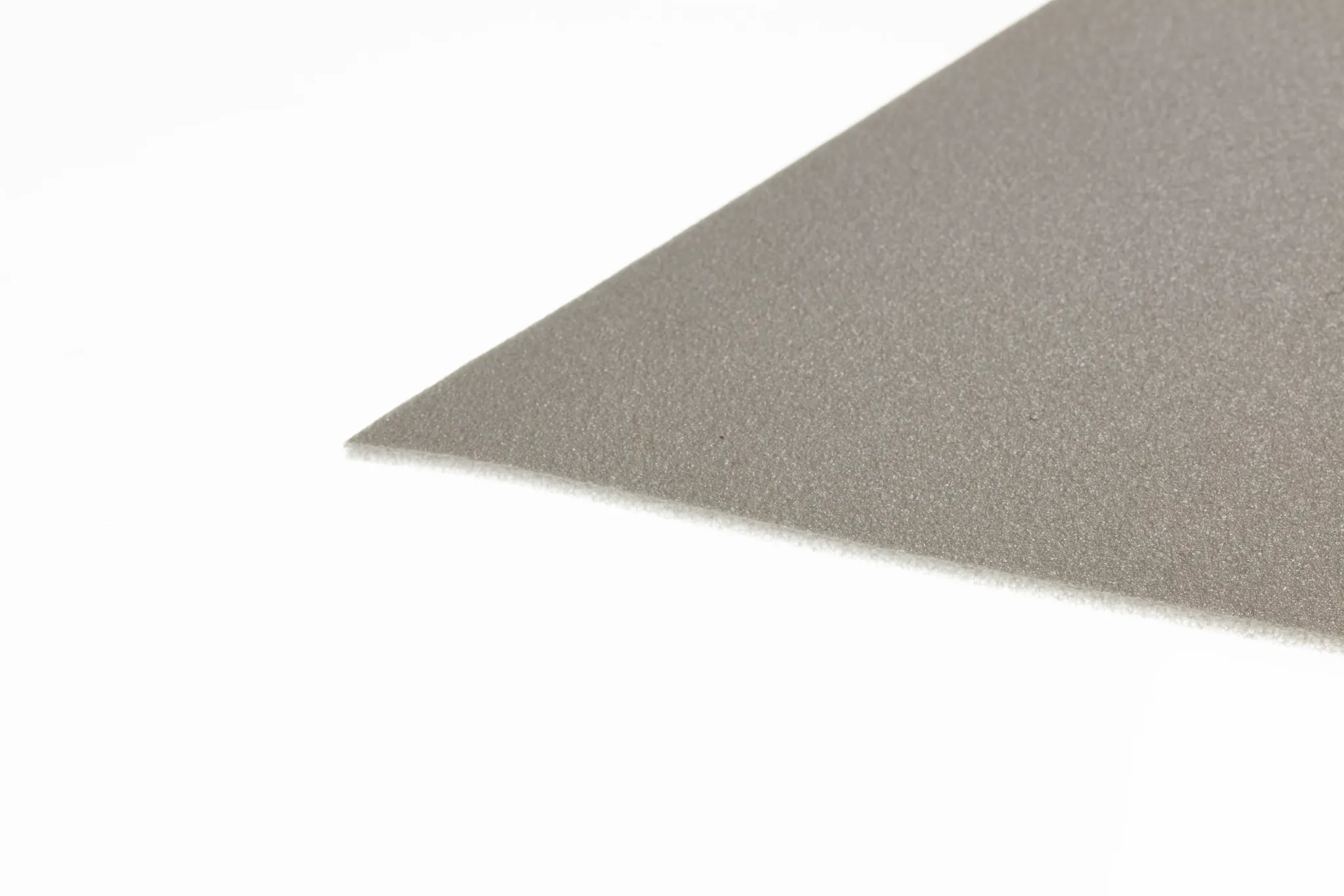 Close-up of a grey flooring swatch with a smooth texture