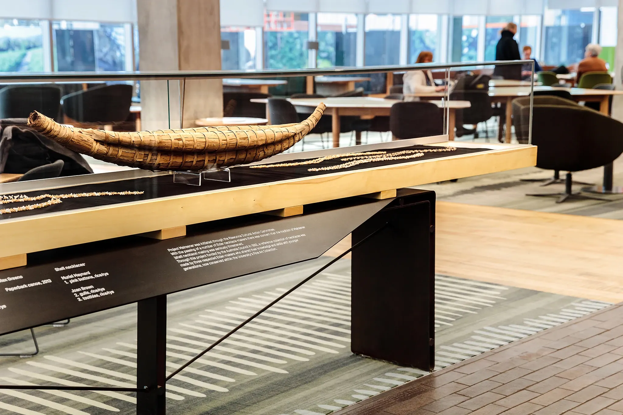 Cultural display within the University of Tasmania learning environment, featuring a woven artefact, custom patterned flooring and collaborative study spaces.