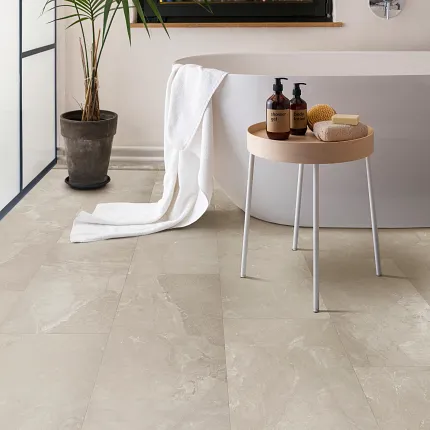 Coretec Mineral Core Residential Luxury Vinyl Tile Flooring - Stone Look, 23.62x11.81 inch Modern bathroom with Coretec Mineral Core Residential luxury vinyl tile flooring in a stone look, featuring a freestanding bathtub, a potted plant, and a small round table with toiletries