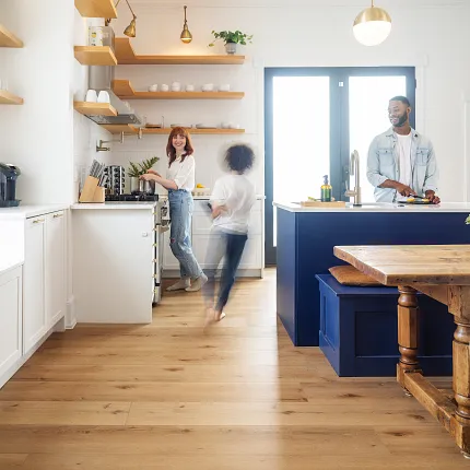 COREtec family in kitchen Family in kitchen preparing a meal and child running through in stop motion style in a blur