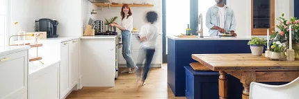 COREtec family in kitchen Family in kitchen preparing a meal and child running through in stop motion style in a blur