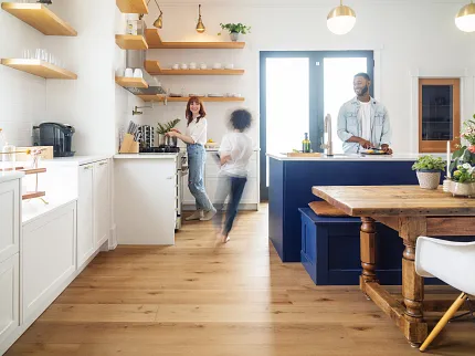 COREtec family in kitchen Family in kitchen preparing a meal and child running through in stop motion style in a blur