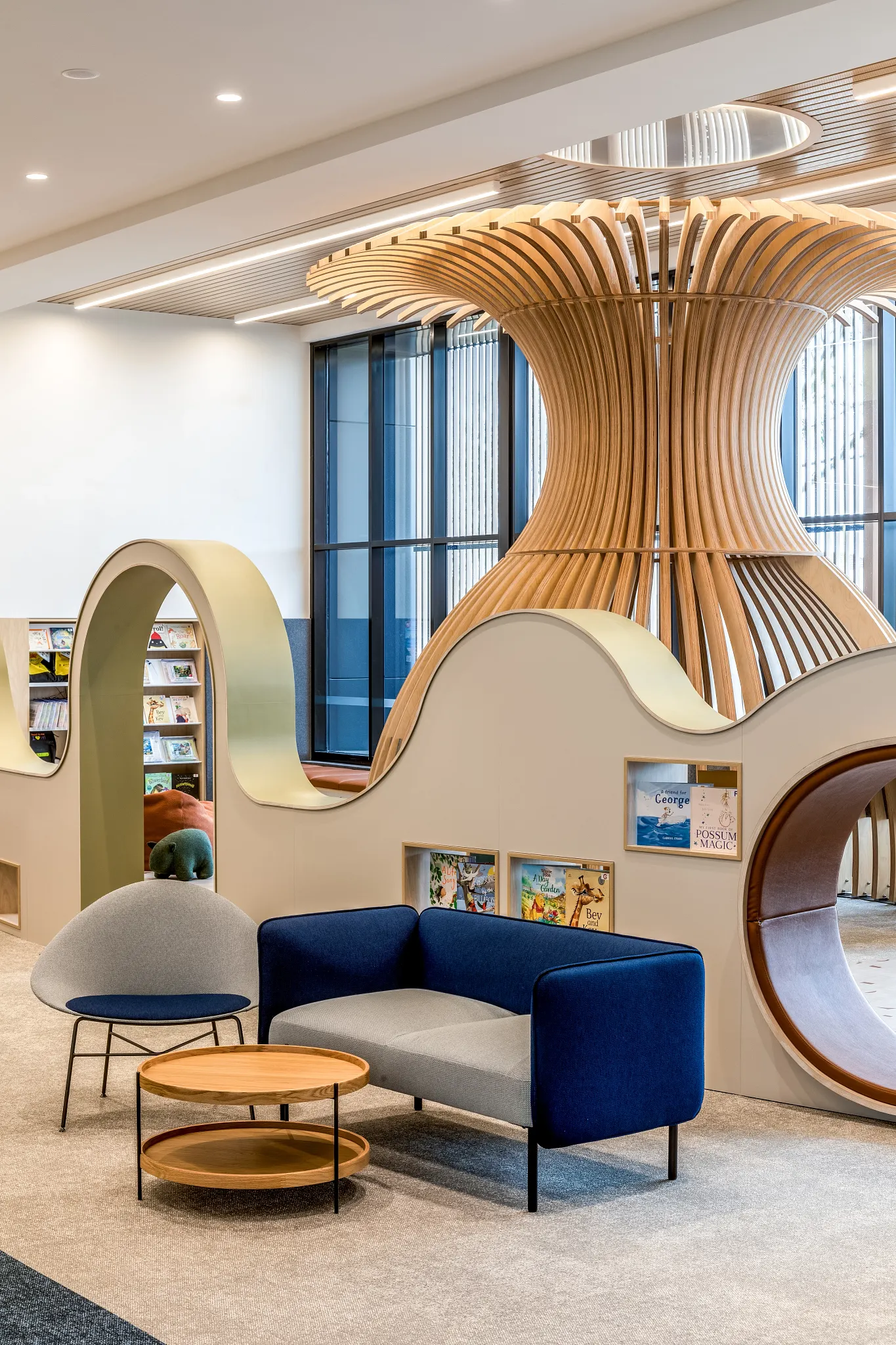 Modern library interior with soft surface flooring and curved shelving