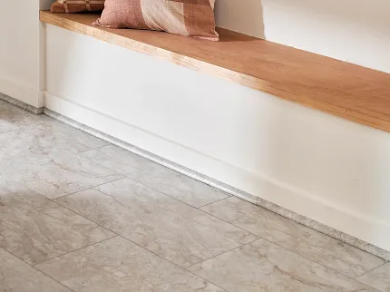 Stone Look Luxury Vinyl Tile Flooring in Modern Living Space Modern living space with stone look luxury vinyl tile flooring featuring beige and gray tones, wooden bench with decorative pillows