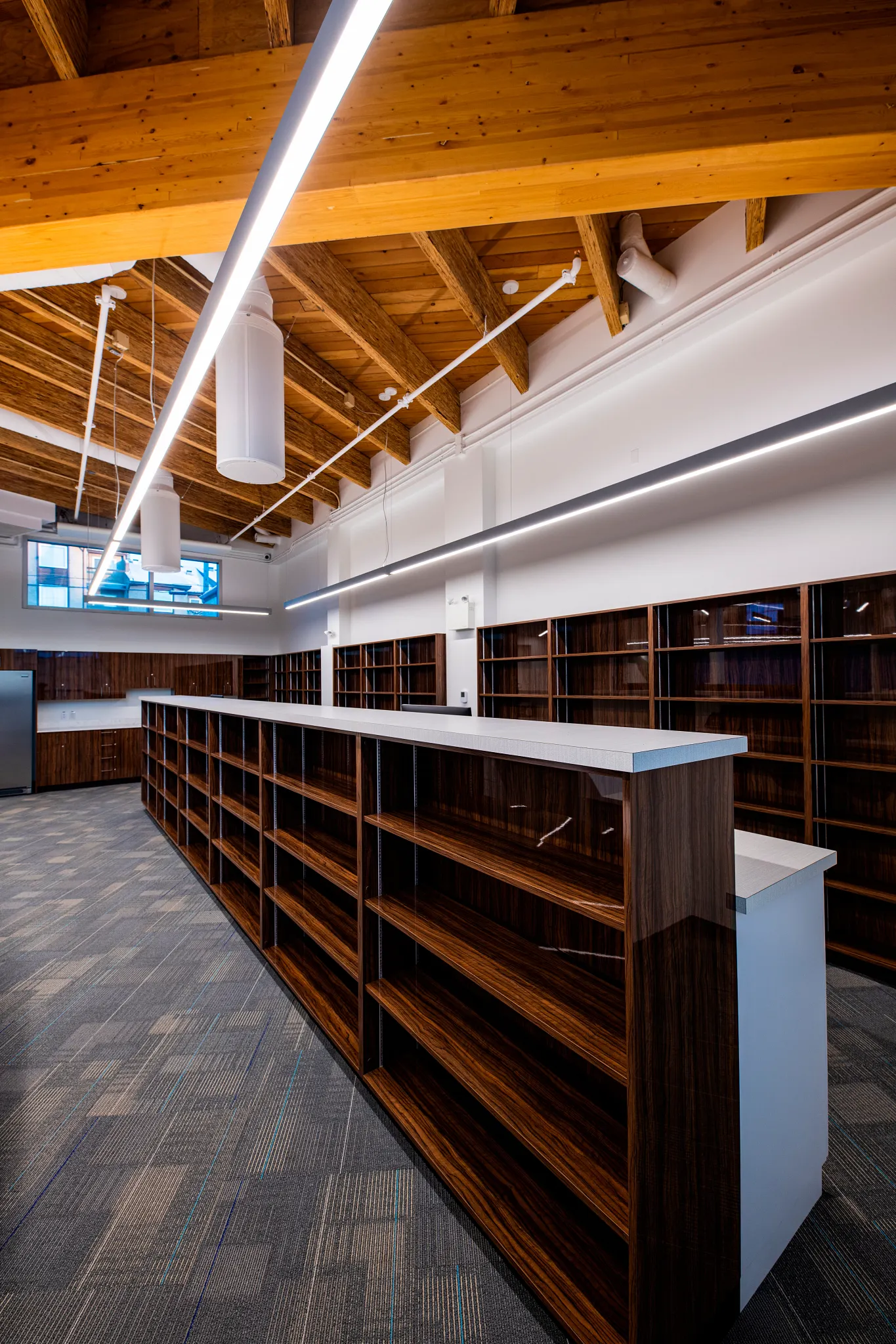 Retail space with wooden ceiling and commercial carpet tile flooring in a 24x24 inch pattern